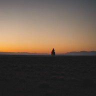 lonely cowboy rides through endless, quiet plains