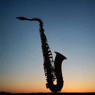 a saxophone cries beneath moonlight